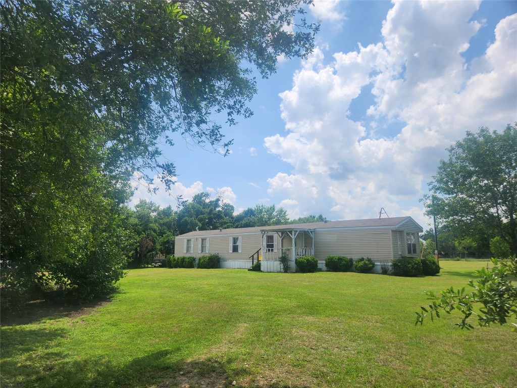 9012 Lucinda Drive Elgin, TX 78621 - Photo 1 of 1 a front view of a house with garden