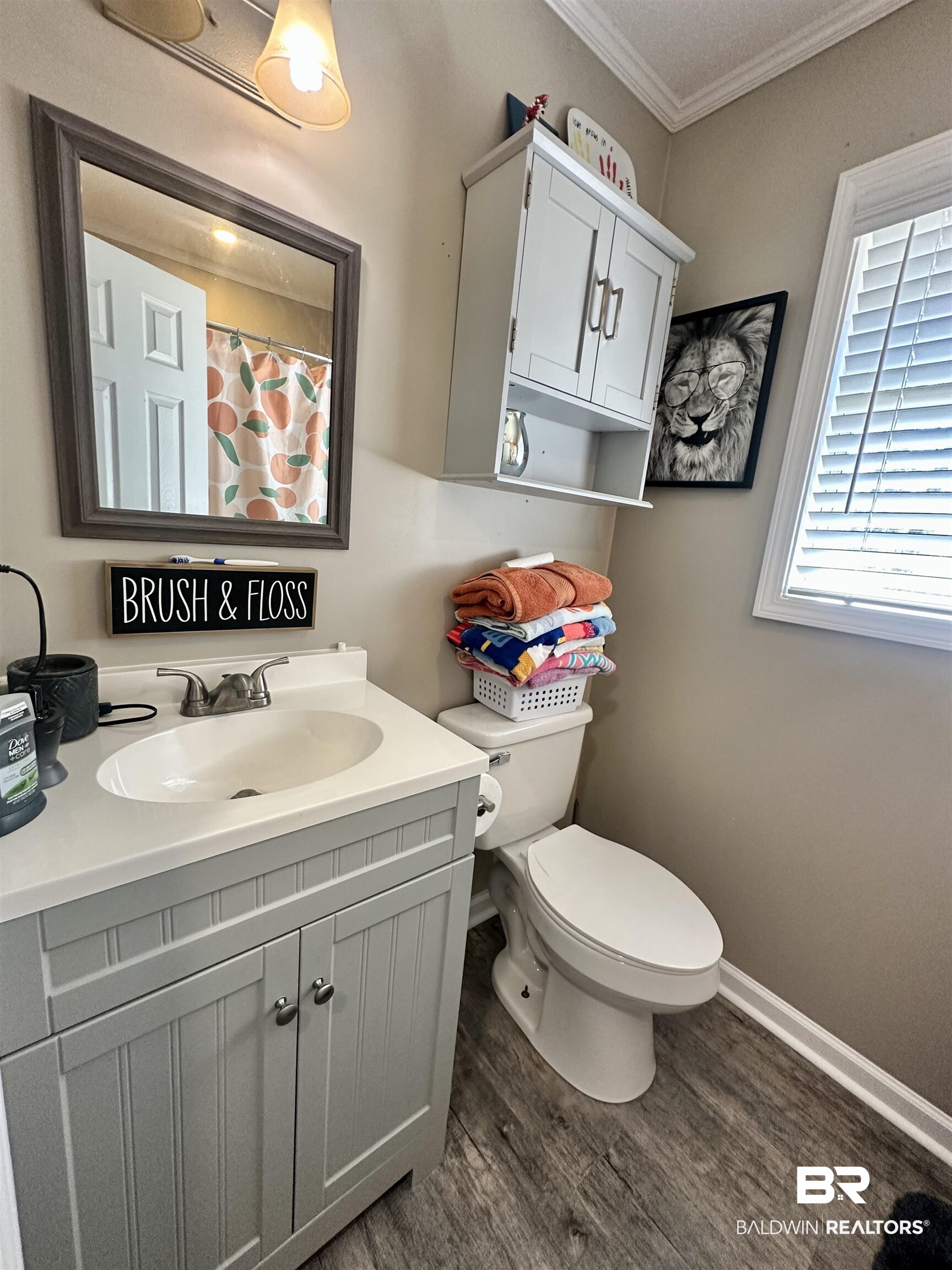 120 McGougin Road Brewton, AL 36426 - Photo 16 of 21 Full bath featuring toilet, wood finished floors, vanity, baseboards, and crown molding