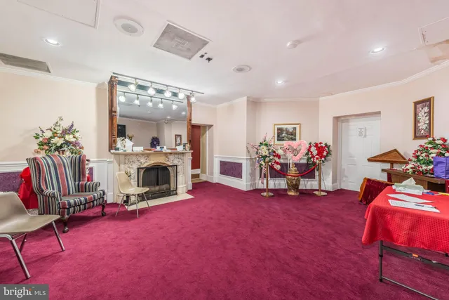 a kitchen with stainless steel appliances kitchen island granite countertop a living room view