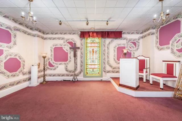 a living room with furniture and a pool table