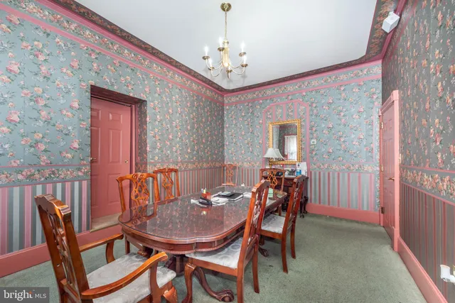 a kitchen with a refrigerator and chair