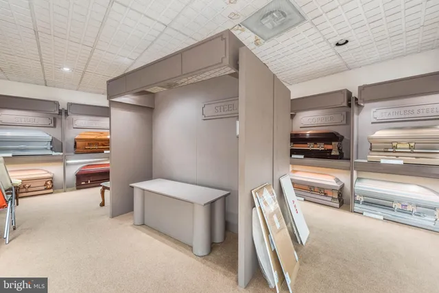 a living room with furniture fireplace and a large window