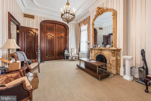 a living room with furniture a chandelier and a window