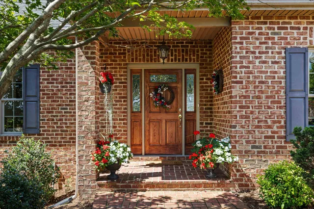 a view of a hallway with wooden floor and windows