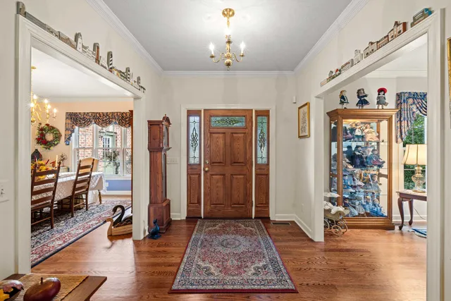 a view of a dining room with furniture a chandelier and wooden floor