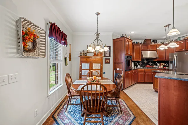 a large kitchen with stainless steel appliances granite countertop a stove and cabinets