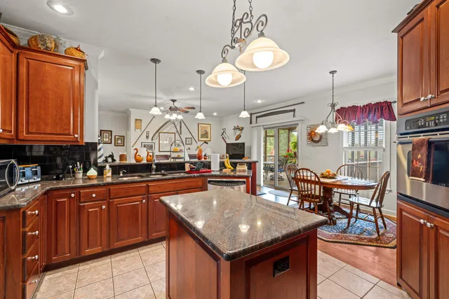 a kitchen with stainless steel appliances granite countertop a stove and cabinets