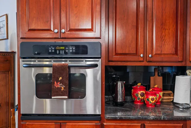 a kitchen sink with granite countertop a sink and a stove