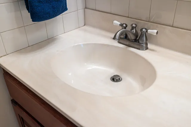 a bathroom with a sink a mirror and a shower