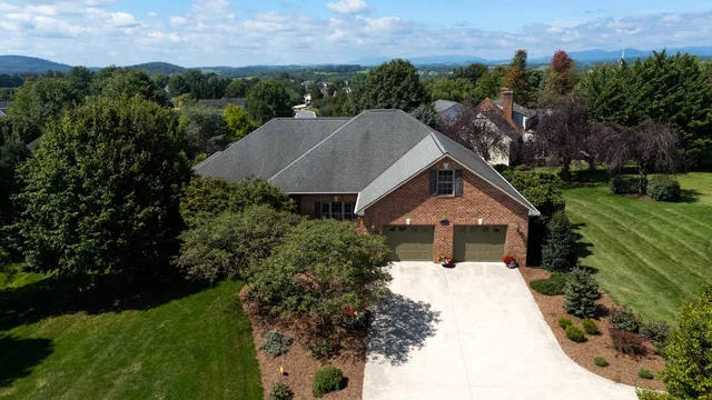 a aerial view of a house with a yard and lake view