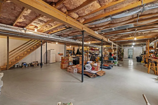 an aerial view of a houses with a yard and lake view