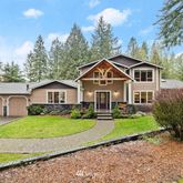 a front view of a house with a garden and yard