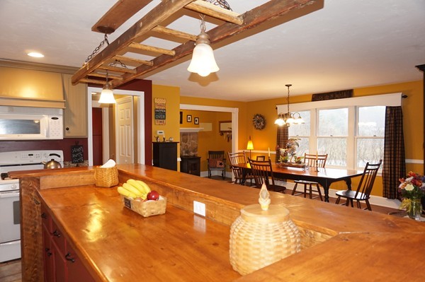 15 Mulpus Road Shirley, MA 01464 - Photo 8 of 30 a dining hall with couches a dining table and chairs with wooden floor