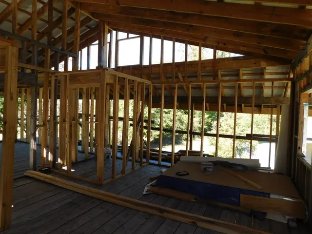 a view of a room with wooden floor and chair