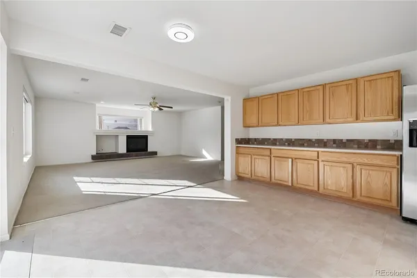a view of kitchen with stainless steel appliances granite countertop a stove and a sink