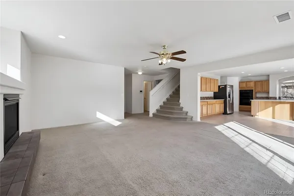 a view of a livingroom with wooden floor and staircase