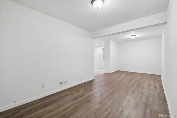 an empty room with wooden floor