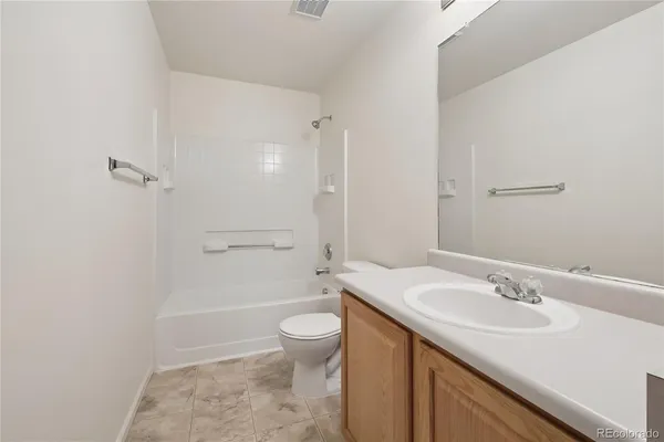 a bathroom with a sink toilet vanity and shower