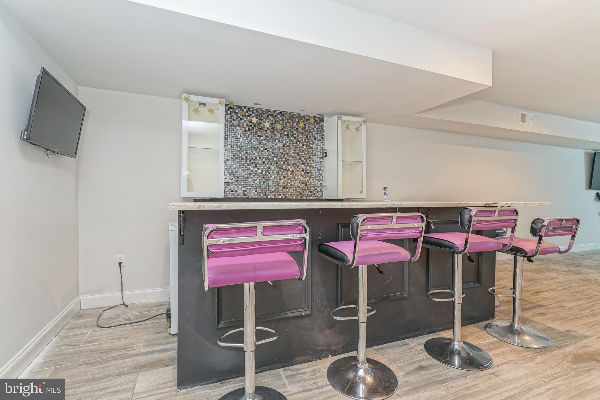 2332 Ellsworth Street Philadelphia, PA 19146 - Photo 23 of 29 a room with a table chairs and wooden floor