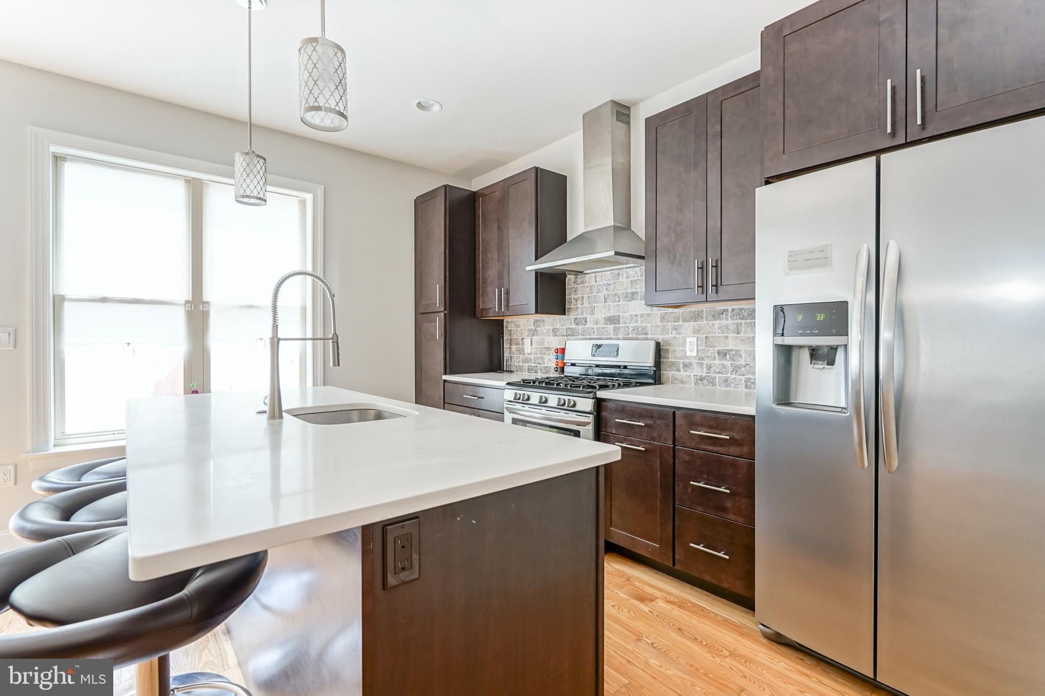 2332 Ellsworth Street Philadelphia, PA 19146 - Photo 5 of 29 a kitchen with stainless steel appliances a refrigerator sink and cabinets