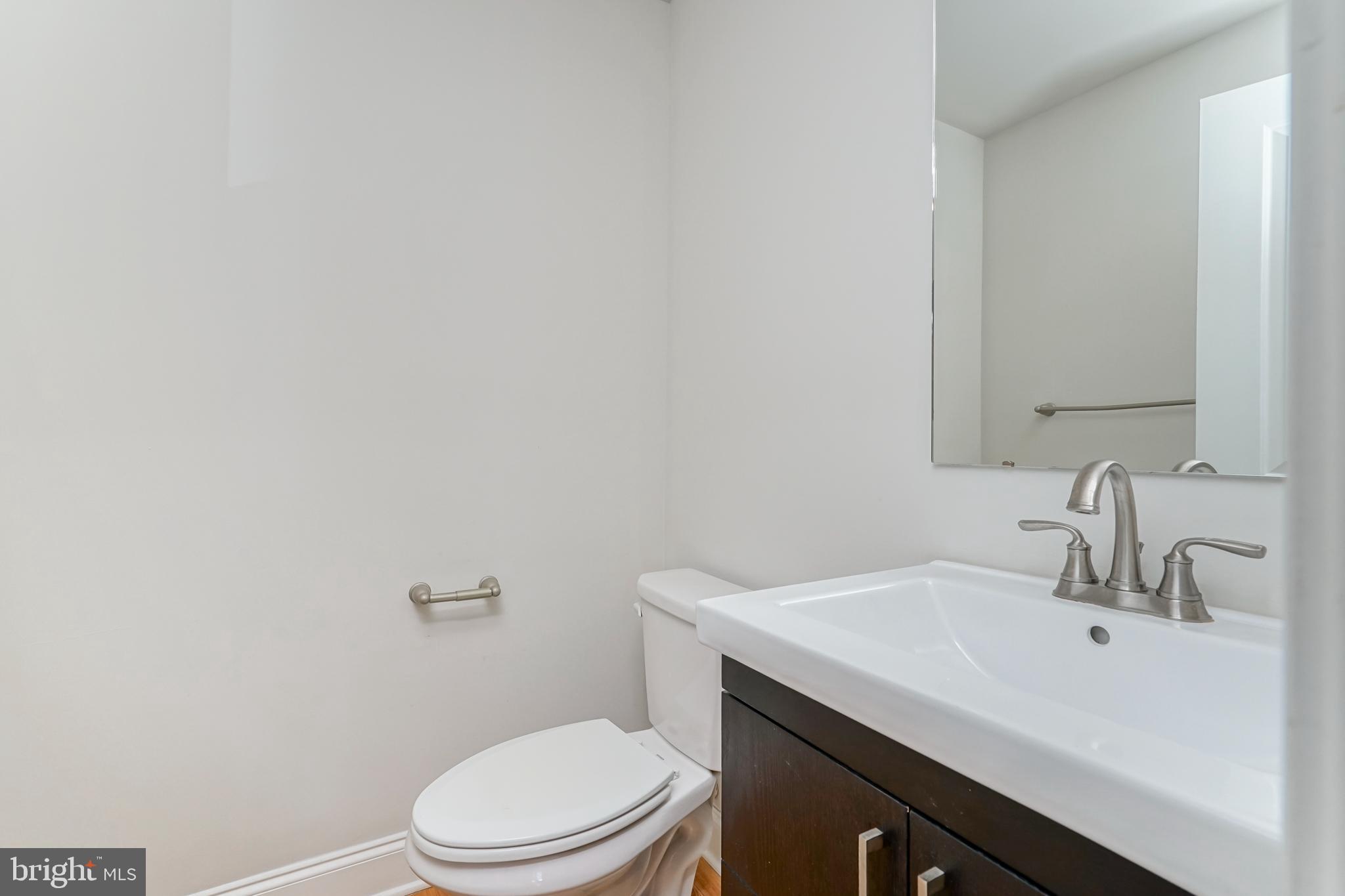 2332 Ellsworth Street Philadelphia, PA 19146 - Photo 9 of 29 a bathroom with a sink a toilet and mirror