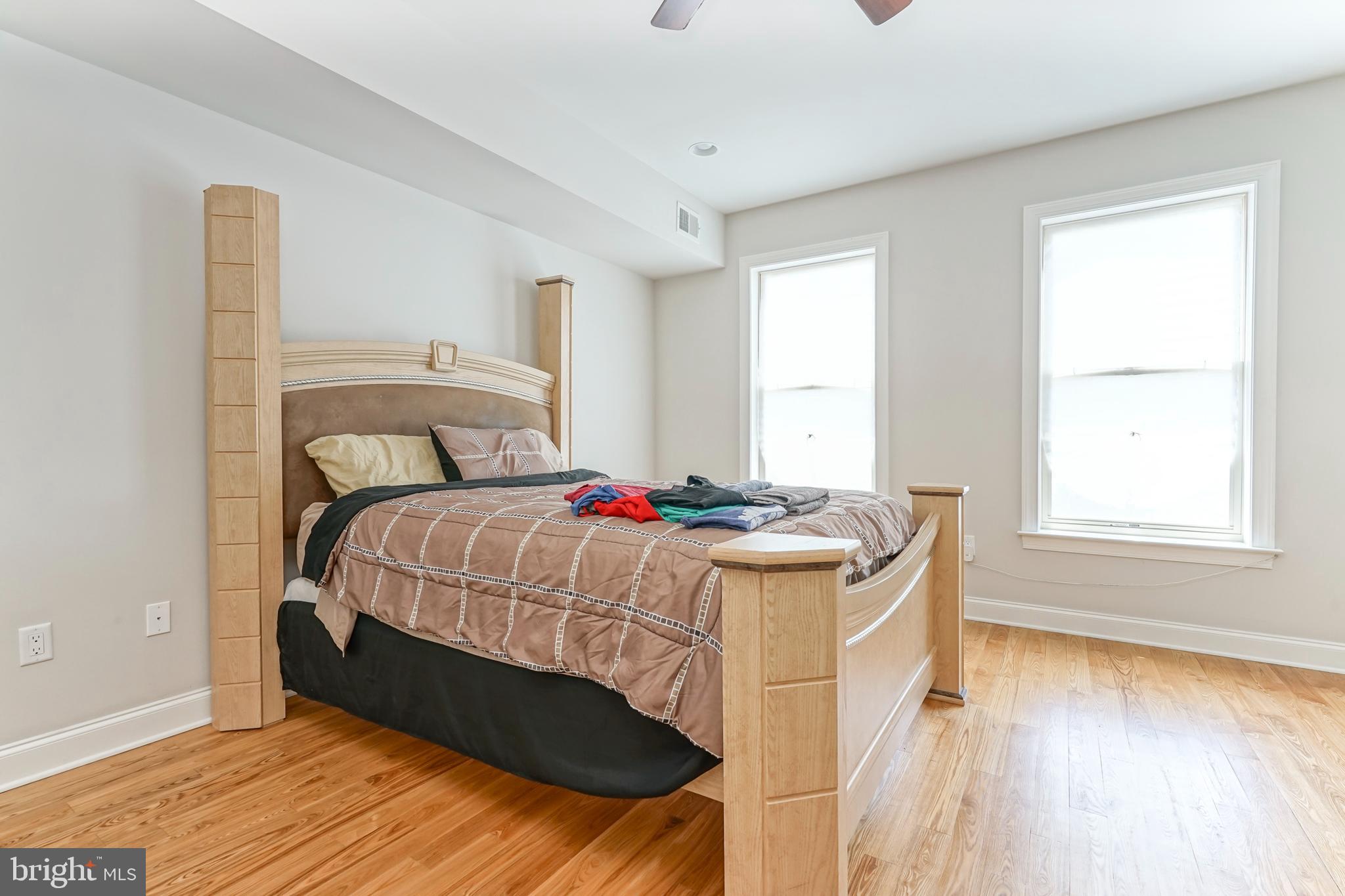2332 Ellsworth Street Philadelphia, PA 19146 - Photo 10 of 29 a bedroom with a bed and wooden floor