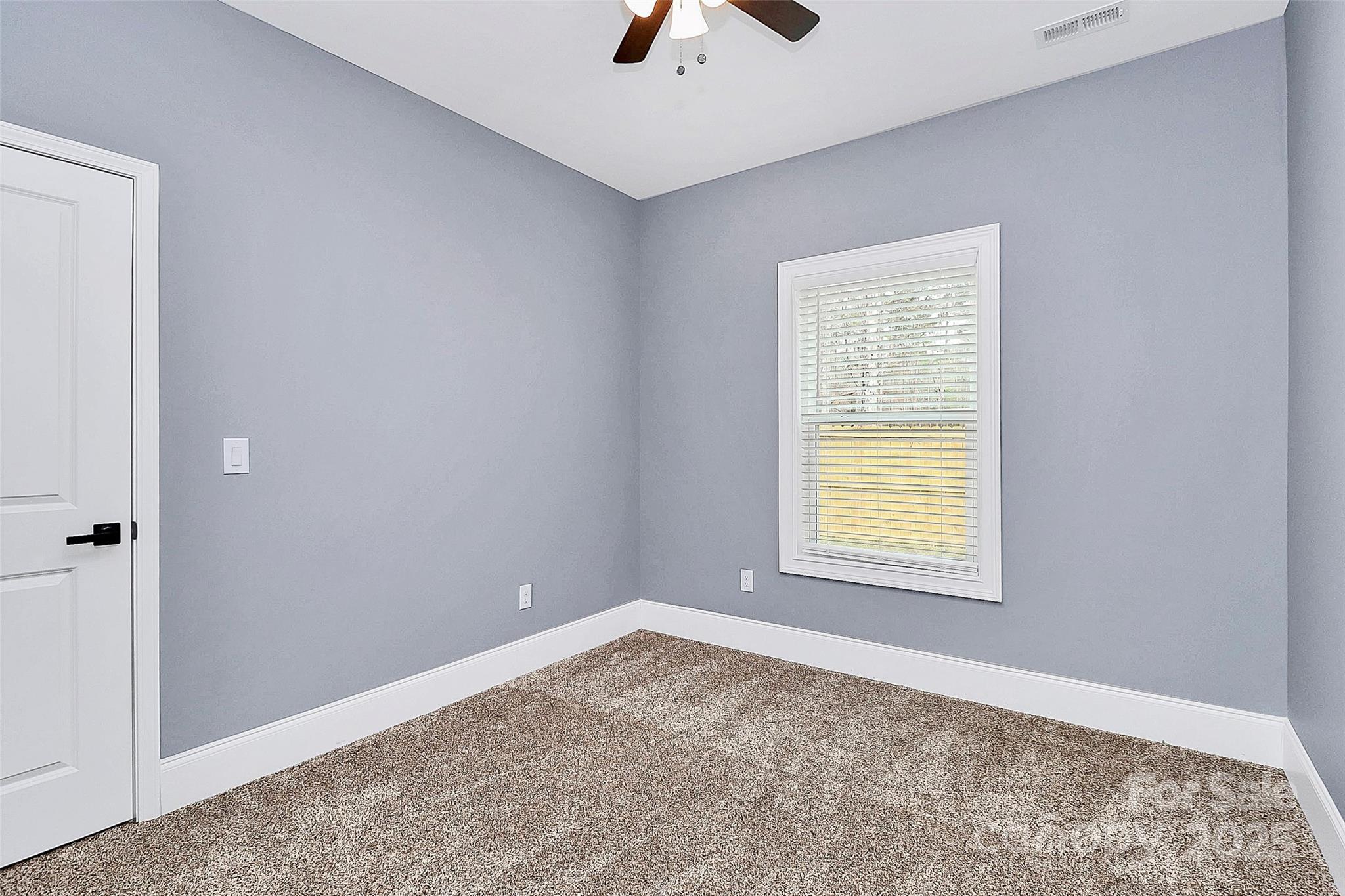 6519 Pargo Road Charlotte, NC 28216 - Photo 15 of 37 an empty room with a window and a ceiling fan