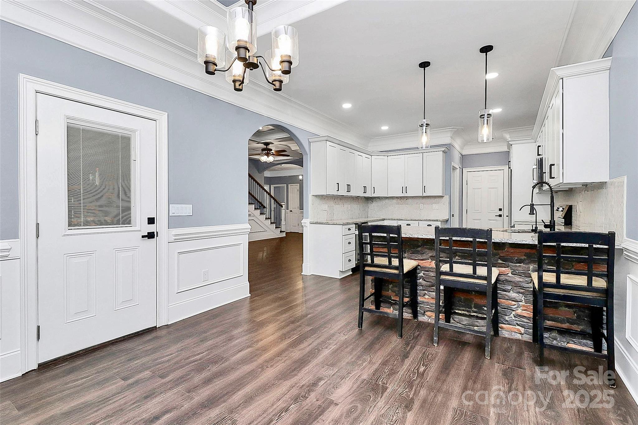 6519 Pargo Road Charlotte, NC 28216 - Photo 26 of 37 a kitchen with kitchen island a dining table chairs sink and cabinets