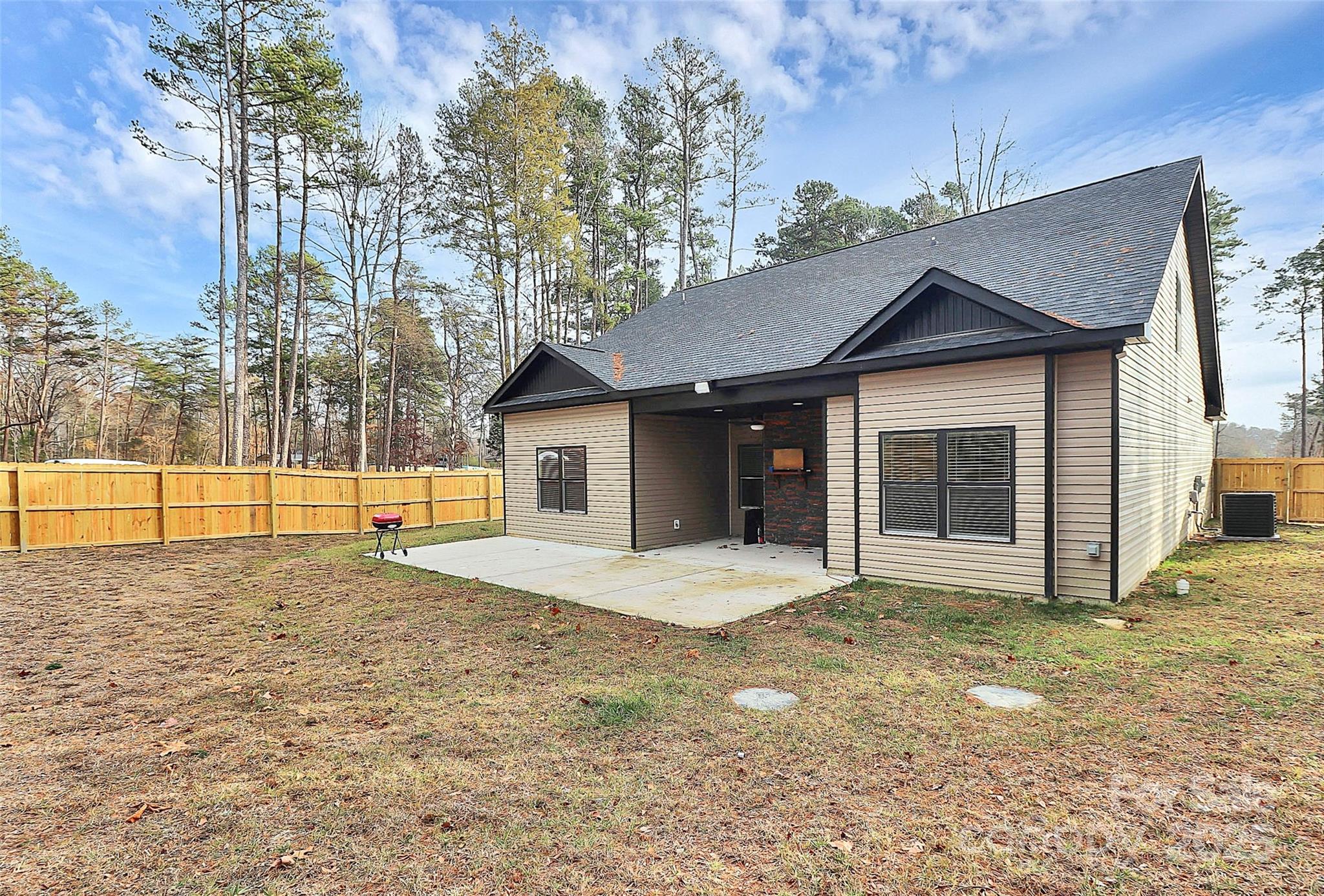 6519 Pargo Road Charlotte, NC 28216 - Photo 35 of 37 a view of a house with a large tree and wooden fence