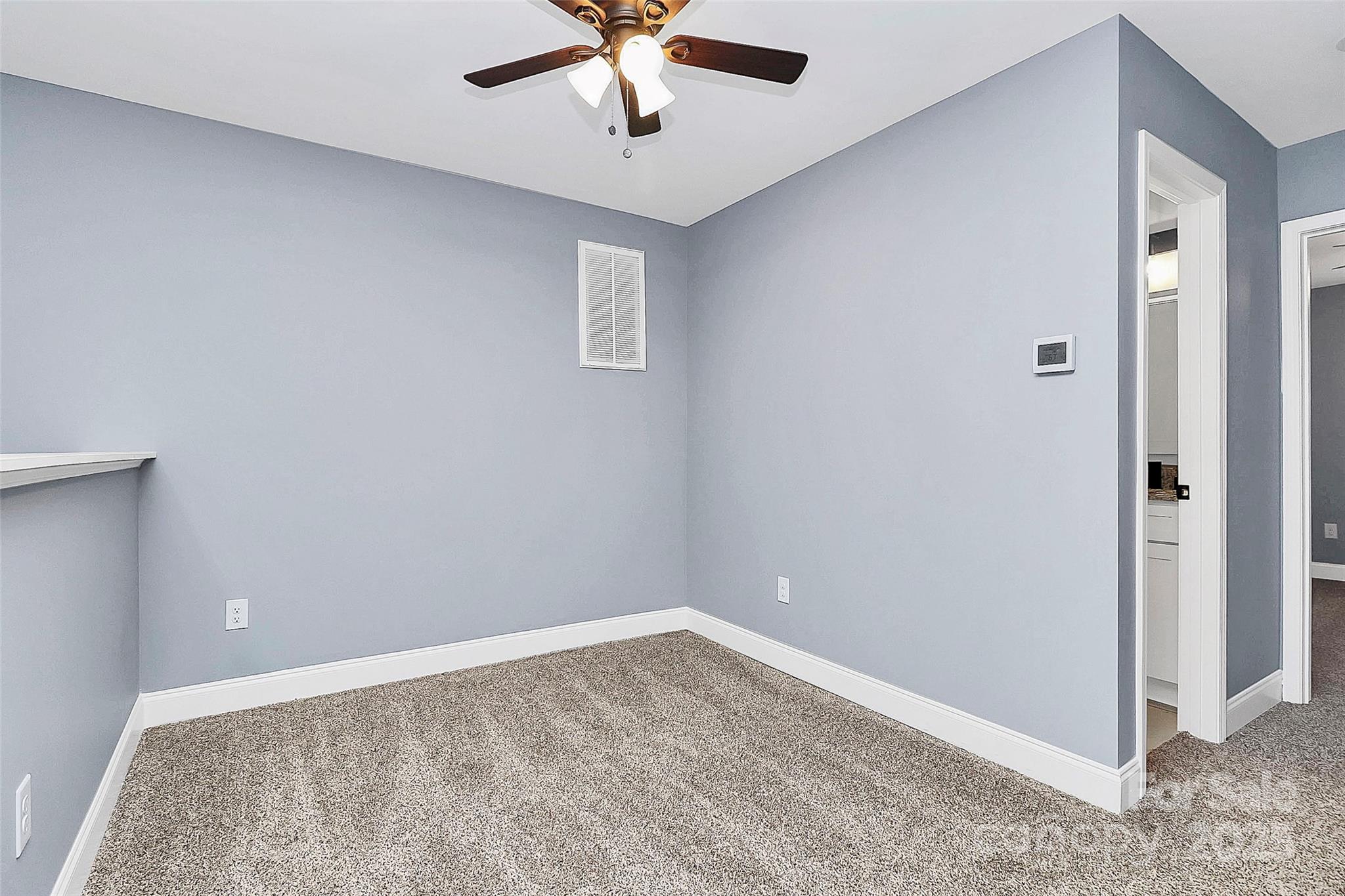 6519 Pargo Road Charlotte, NC 28216 - Photo 7 of 37 an empty room with a ceiling fan and carpet