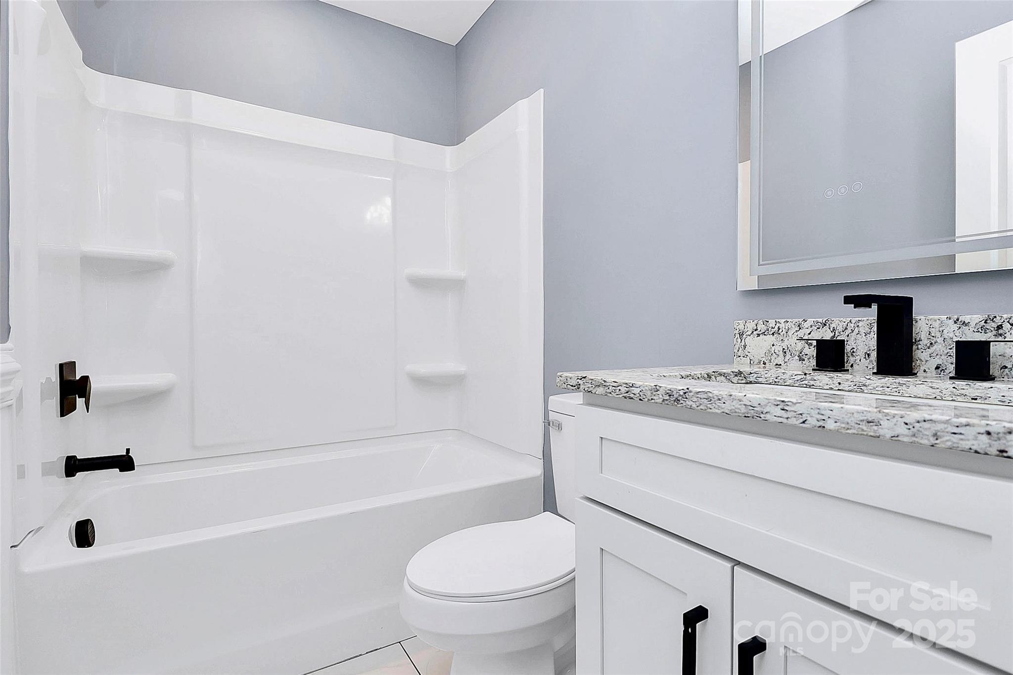 6519 Pargo Road Charlotte, NC 28216 - Photo 9 of 37 a bathroom with a granite countertop sink a toilet and bathtub