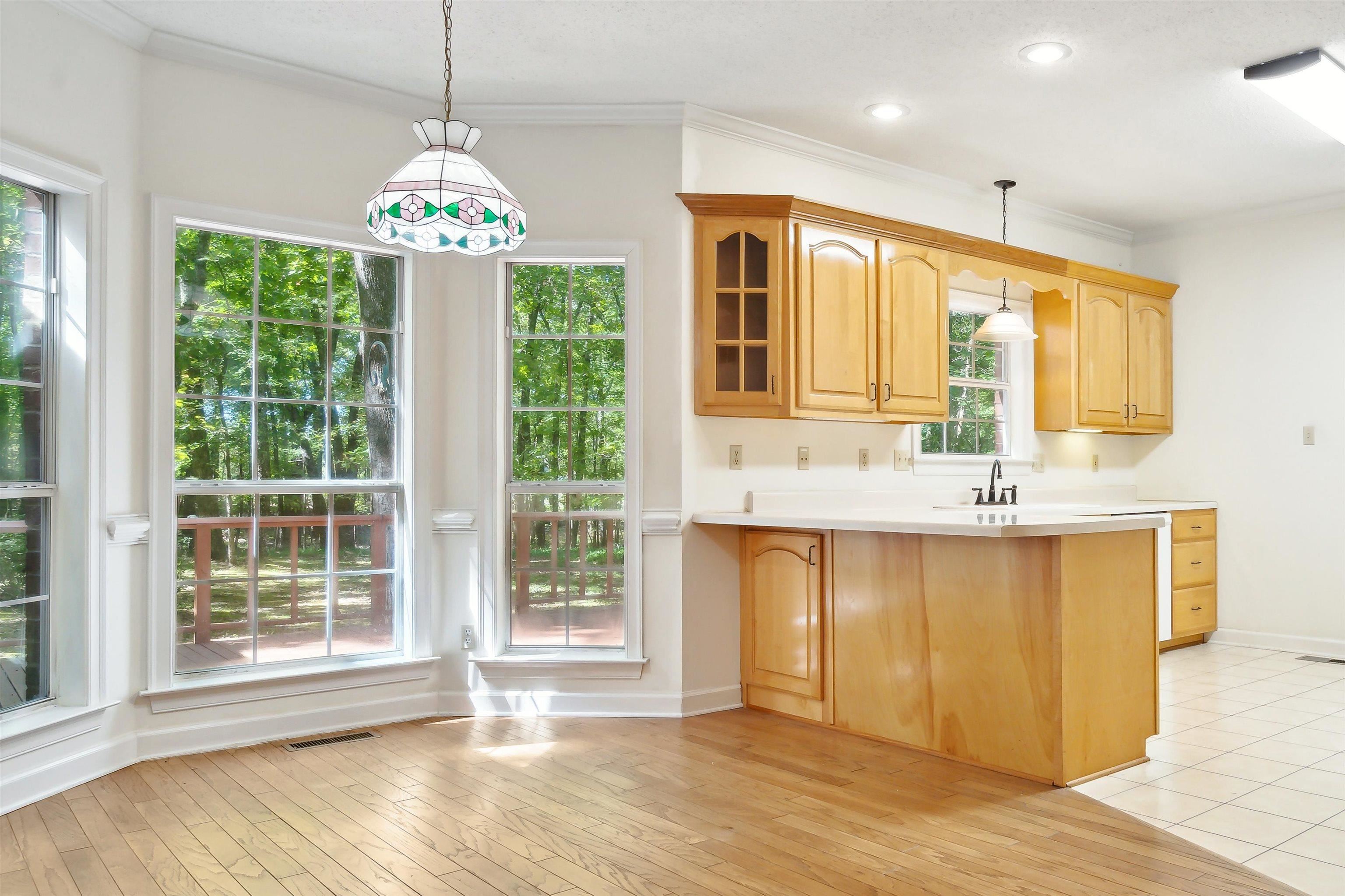 3255 Highway 196 Piperton, TN 38017 - Photo 12 of 22 a view of a kitchen with granite countertop wooden floor and a chandelier