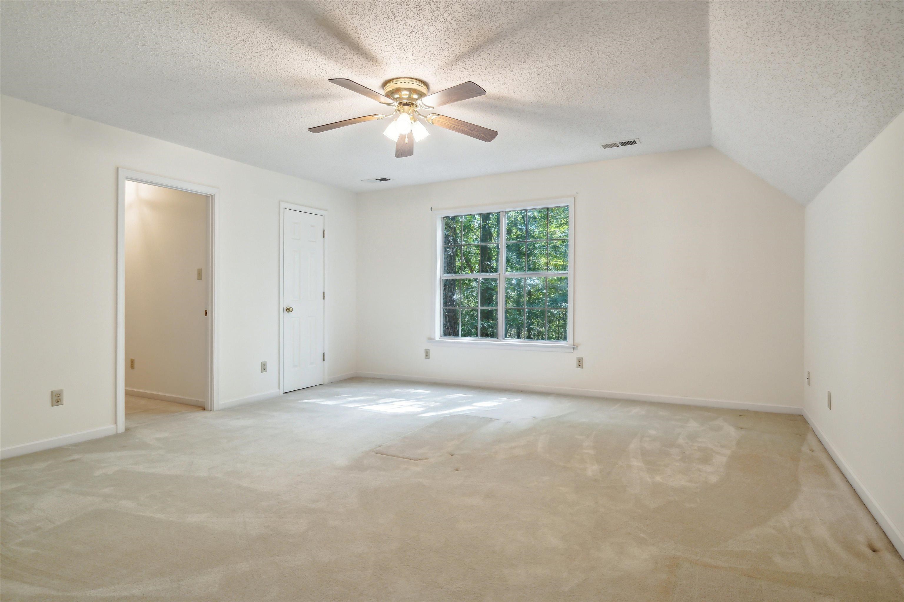 3255 Highway 196 Piperton, TN 38017 - Photo 18 of 22 an empty room with chandelier fan and windows