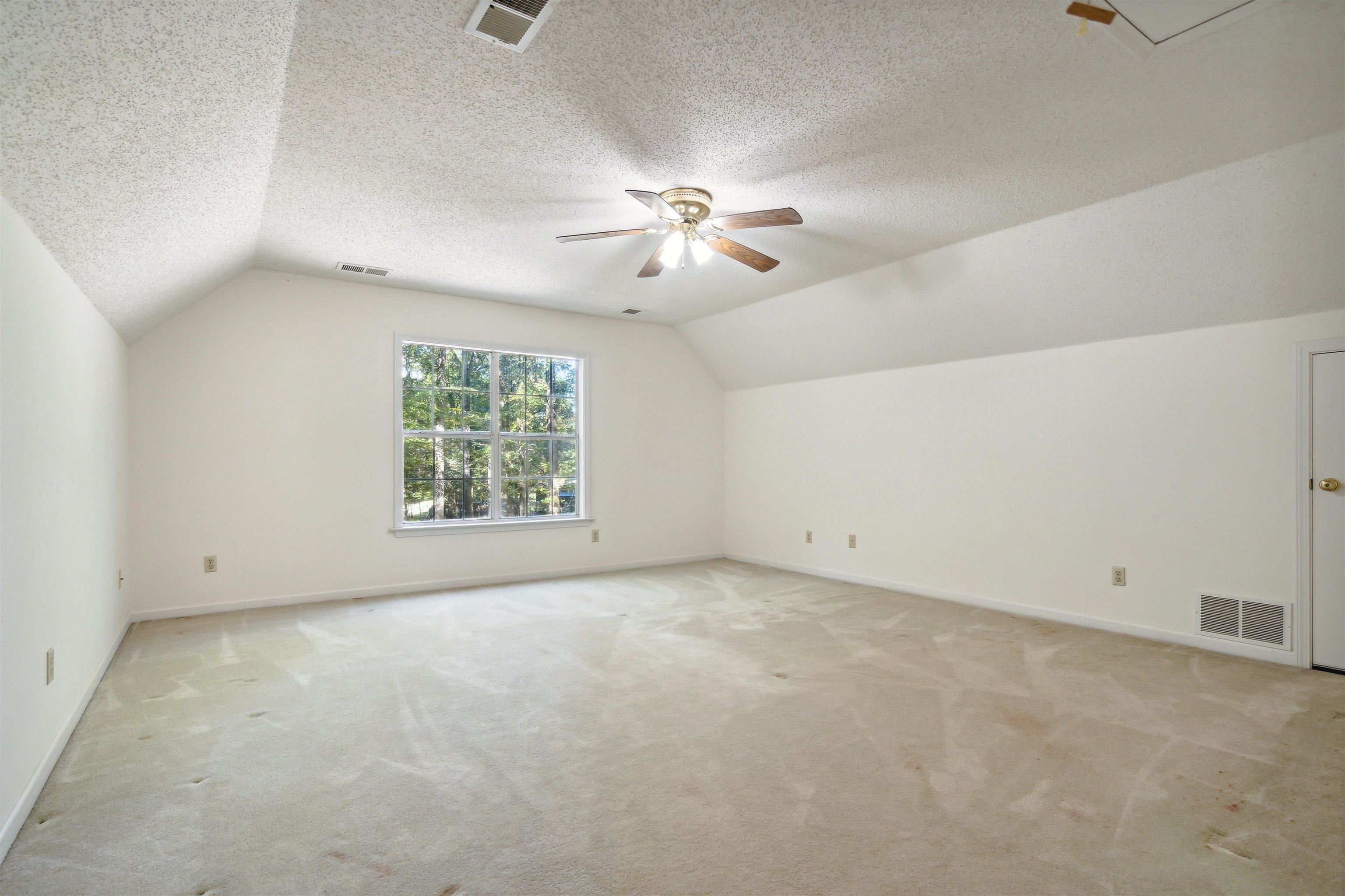 3255 Highway 196 Piperton, TN 38017 - Photo 21 of 22 an empty room with a window and a ceiling fan