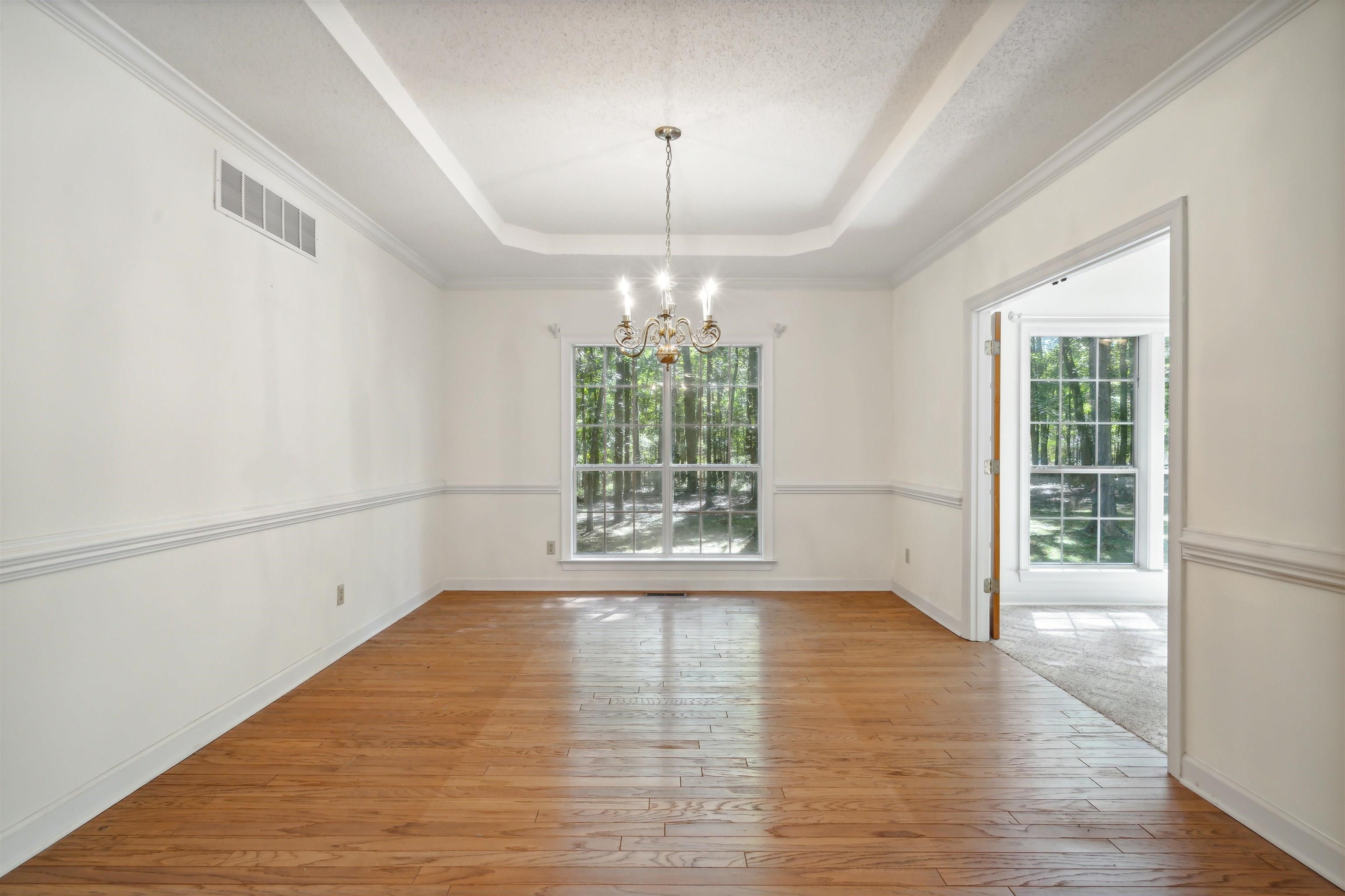 3255 Highway 196 Piperton, TN 38017 - Photo 10 of 22 a view of an empty room with wooden floor and a window