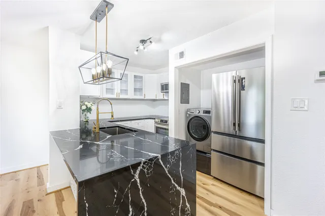 a view of a dining table chairs and chandelier