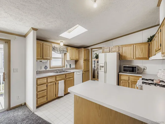 a kitchen with refrigerator a sink and cabinets