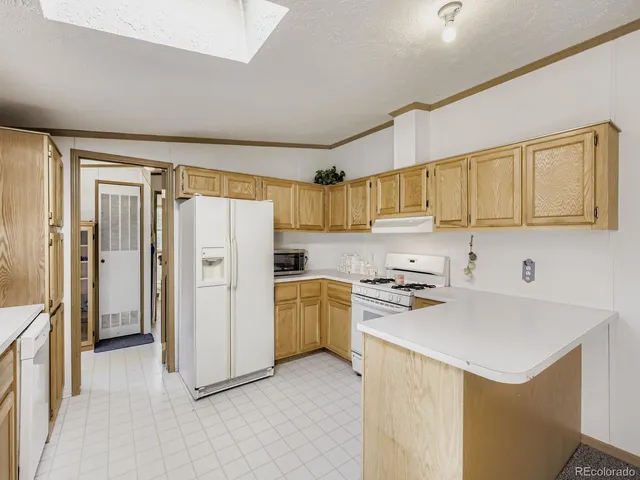 a kitchen with a refrigerator a stove top oven a sink and dishwasher