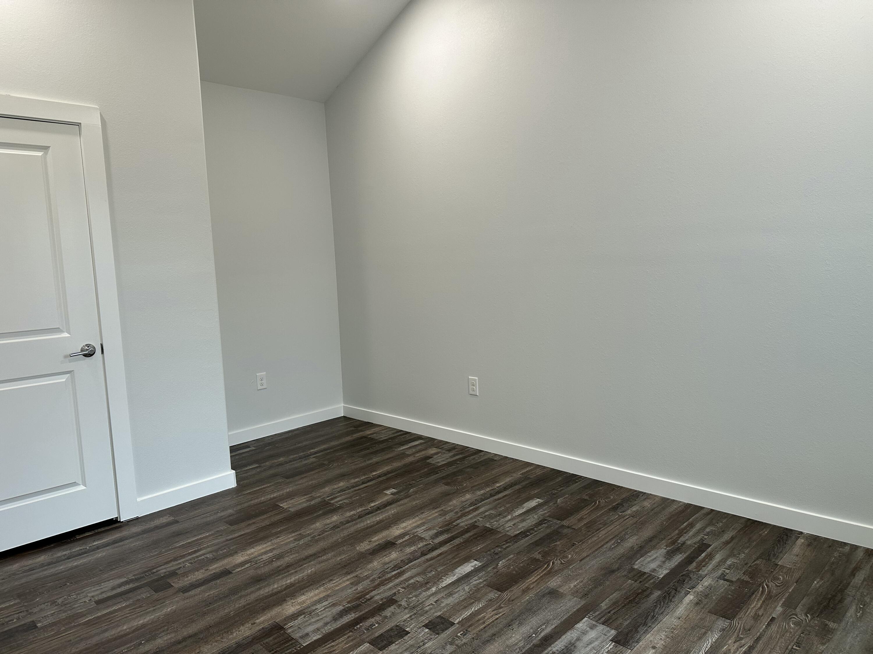 524 North Raphael Road DeFuniak Springs, FL 32433 - Photo 13 of 15 a view of an empty room with wooden floor
