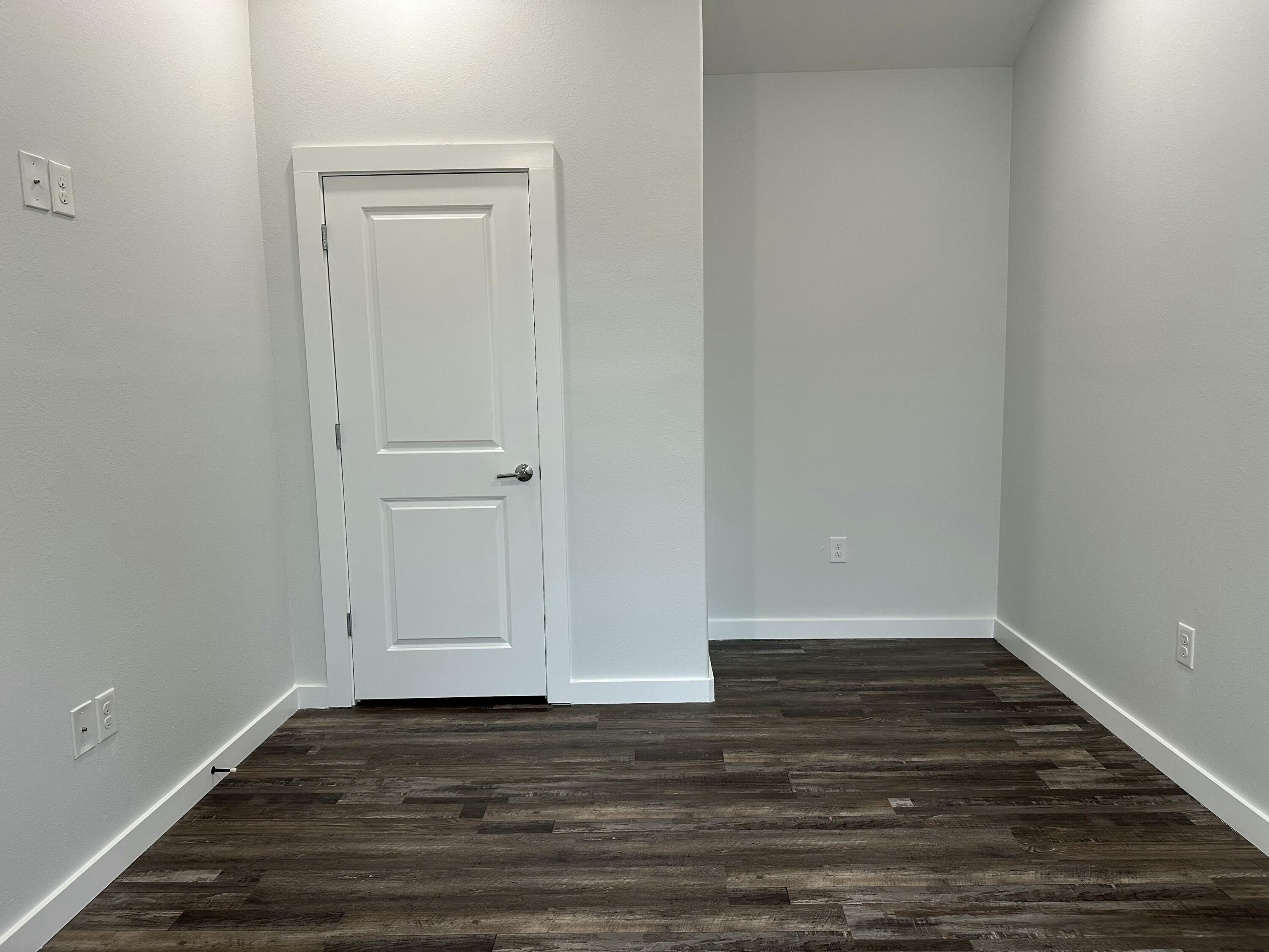 524 North Raphael Road DeFuniak Springs, FL 32433 - Photo 14 of 15 a view of an empty room with wooden floor