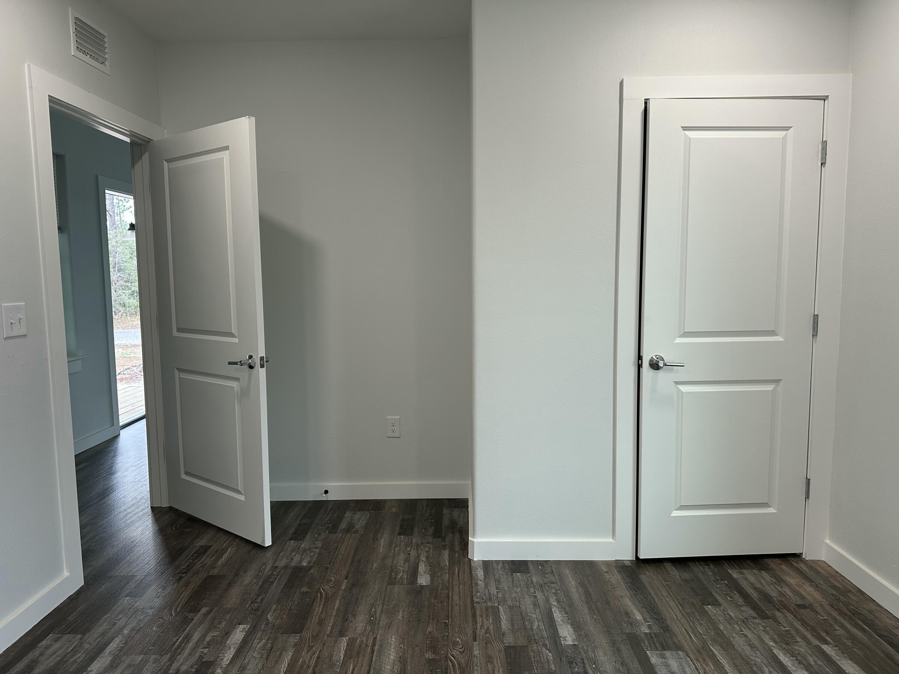 524 North Raphael Road DeFuniak Springs, FL 32433 - Photo 7 of 15 an empty room with wooden floor and closet area