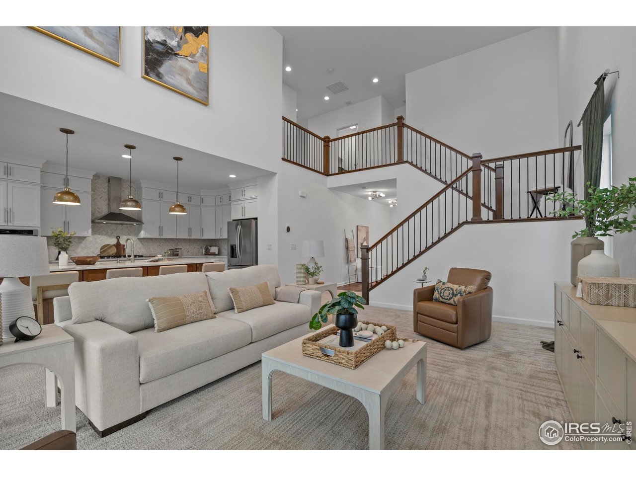 5070 Kidd Street Timnath, CO 80547 - Photo 12 of 42 a living room with furniture and a dining table with kitchen view