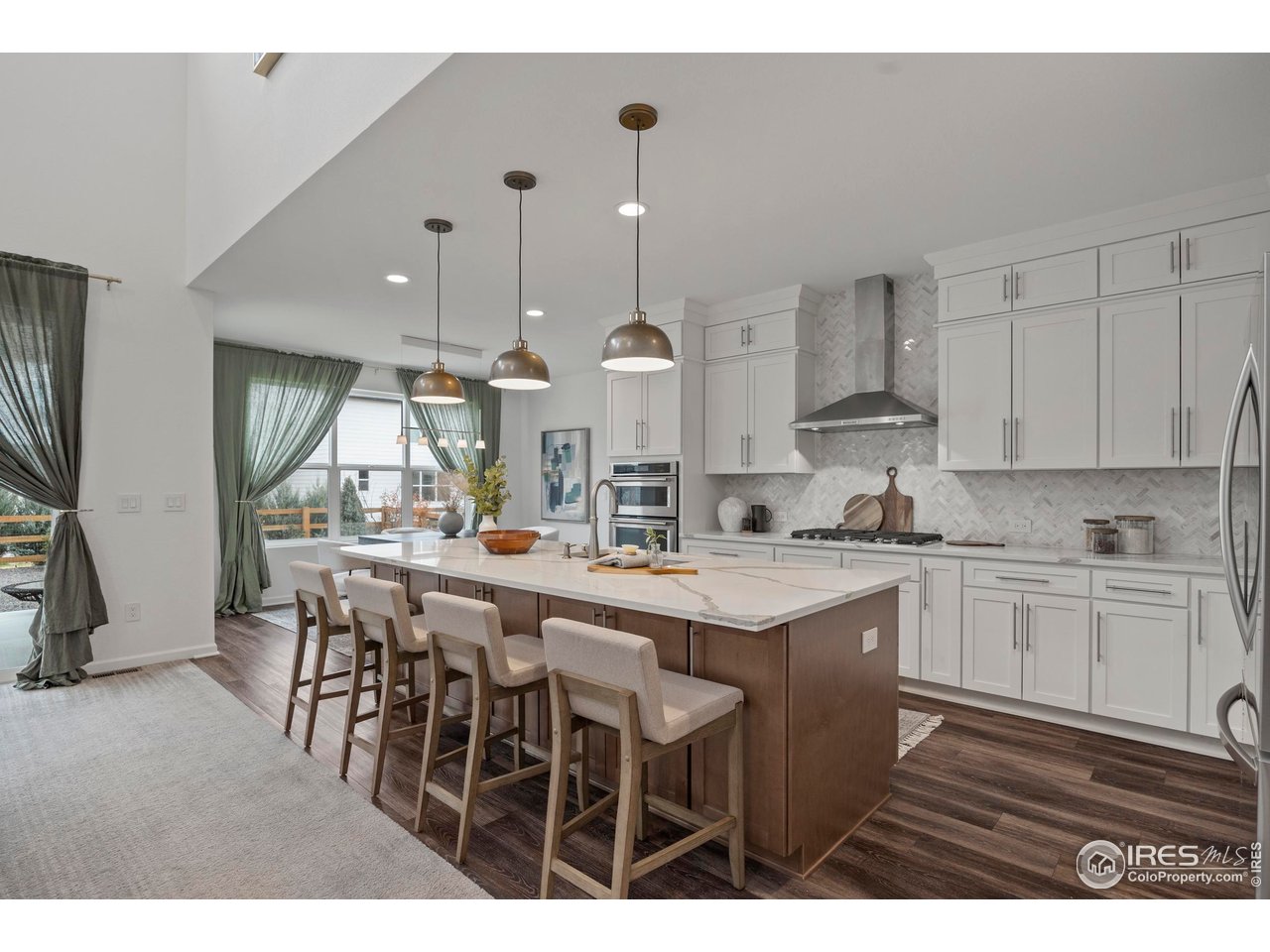 5070 Kidd Street Timnath, CO 80547 - Photo 14 of 42 a kitchen with stainless steel appliances granite countertop a sink a stove a refrigerator and island