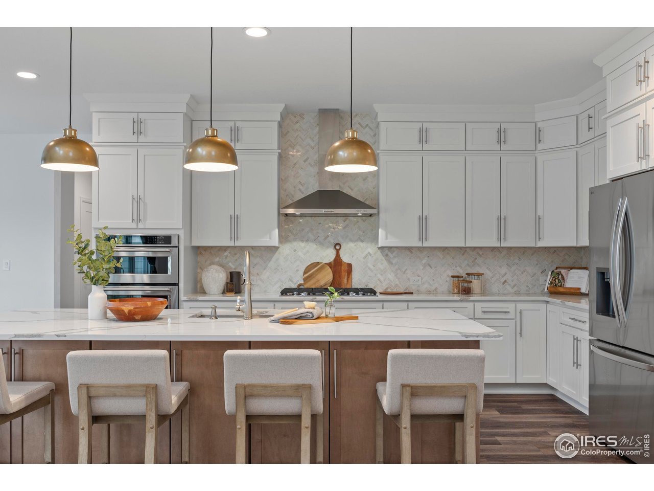 5070 Kidd Street Timnath, CO 80547 - Photo 17 of 42 a kitchen with stainless steel appliances granite countertop a sink a stove a dining table and chairs