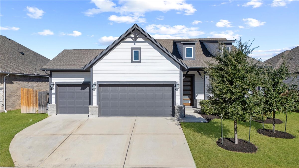 a front view of a house with garden