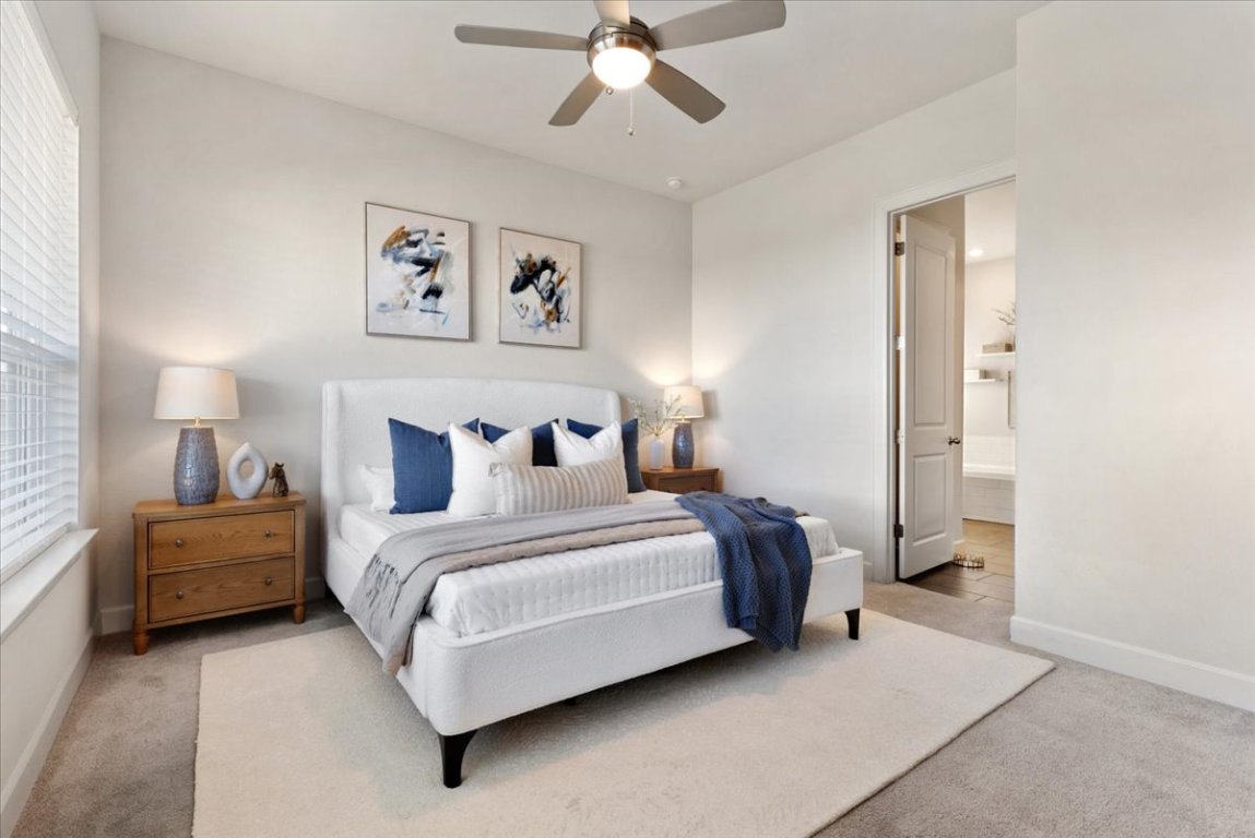 908 Knowles Drive Hutto, TX 78634 - Photo 15 of 37 a bedroom with bed and a chandelier