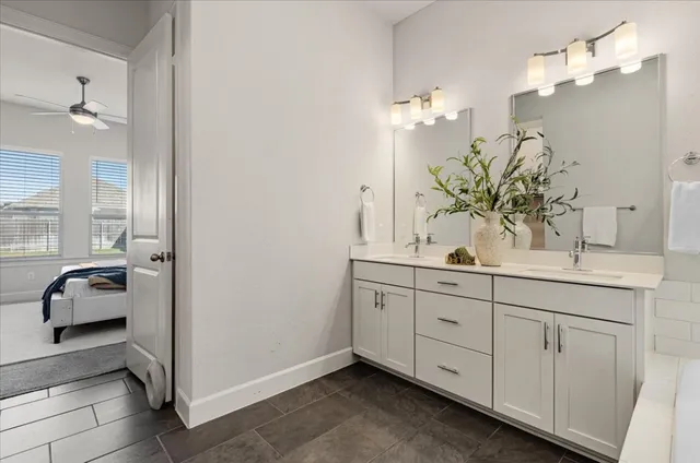 a bathroom with a double vanity sink and a mirror