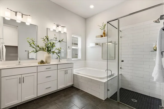 a bathroom with a tub sink and mirror