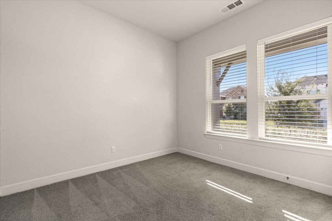 908 Knowles Drive Hutto, TX 78634 - Photo 20 of 37 an empty room with a window