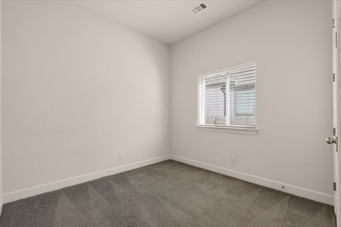 908 Knowles Drive Hutto, TX 78634 - Photo 22 of 37 an empty room with a window